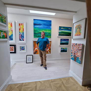 Artist in his home gallery